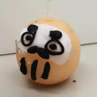 桃色ダルマのロウソク人形