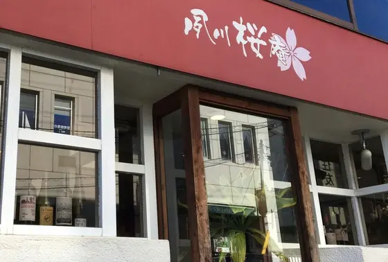お店の目印はえんじ色の看板