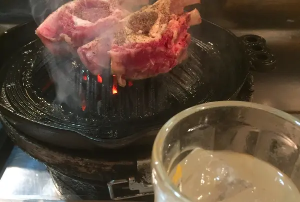 大きなラムチョップにかぶりつく